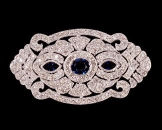 Lot 220  |  SAPPHIRE & DIAMOND 18K WHITE GOLD PIN  |  Having three faceted sapphires set in a diamond-encrusted openwork pin, with fineness marks; 2.5 in., 10.8g