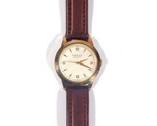 Lot 226  |  TIFFANY & CO. 14K WRISTWATCH  |  14k yellow gold case with fineness mark on the back, the face signed "Tiffany & Co. / automatic / Switzerland," possibly Movado movement, in original box; total weight 47.3g dia. 35mm (case over crown)
