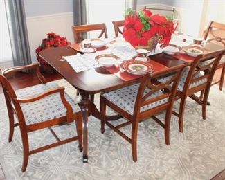 Beautiful mahogany dining table with six chairs. (One arm chair.) Rug shown is not for sale.