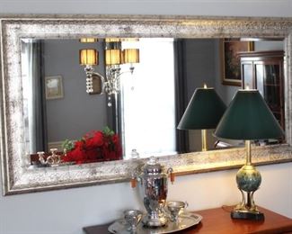 Large mirror, server, coffee service and lamp.