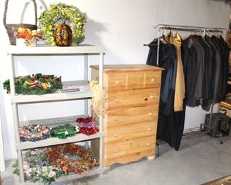 Wreaths, chest of drawers and men's clothing.