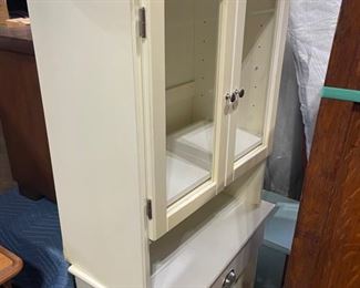 White Cabinet with glass doors. Perfect for bathroom or laundry room.