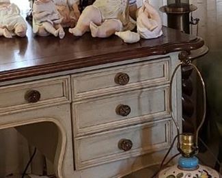  Collection of piano babies on top of my French inspired light wood desk. Both hard to find items.