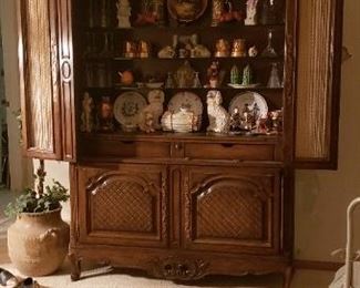 Lower cabinet doors reveal drawers and shelf when opened. Actually a bar but used for China cabinet.
