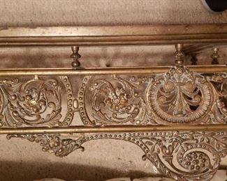 Fireplace fender made from brass with exquisite scrolling design. Also 2 andirons. Sits on hearth to enhance fireplace. Prettiest one you will find! Rare item.