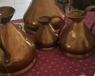 Large antique brass pitchers. 4 different sizes in set.