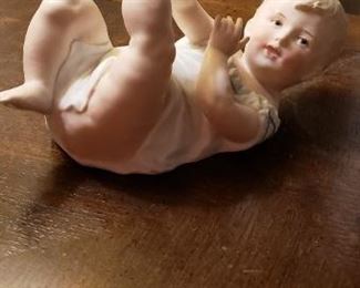 Several Piano baby figurines with beautiful pained features. These are antiques!