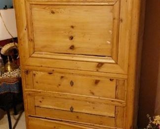Beautiful pine cabinet with locking top door and bottom drawer. Inside of cabinet has partitions to hold clothes, books--whatever you need to store.