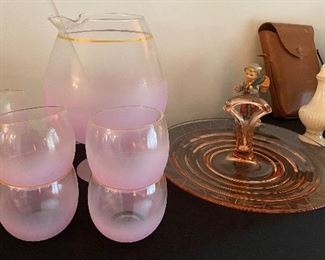 Cocktails in pink frosted glassware and some treats upon a pink depression glass serving tray