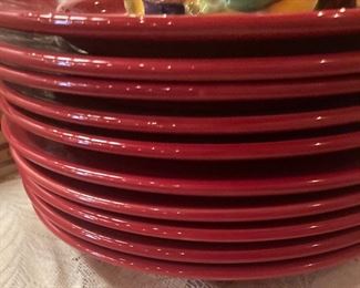 We have two stacks of red dinner plates