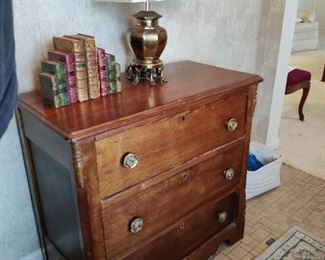 antique three drawer dresser, deco bookends, lamp