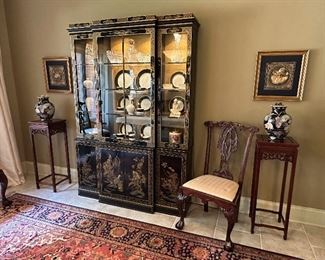 Black lacquer chinoiserie cabinet from Hinson Galleries in Columbus GA flanked by two asian inspired mahogany stands.  Two framed Indonesian embroideries hang on wall.  8' x 10' Karastan rug on floor.