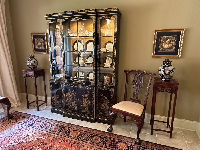 Black lacquer chinoiserie cabinet from Hinson Galleries in Columbus GA flanked by two asian inspired mahogany stands.  Two framed Indonesian embroideries hang on wall.  8' x 10' Karastan rug on floor.