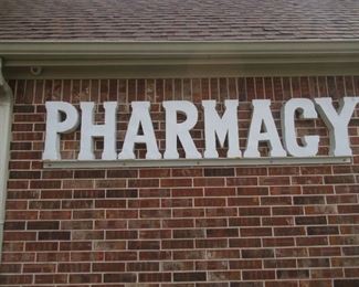 METAL PHARMACY SIGN 95 X 21 MUST BRING TOOLS AND LADDER TO REMOVE