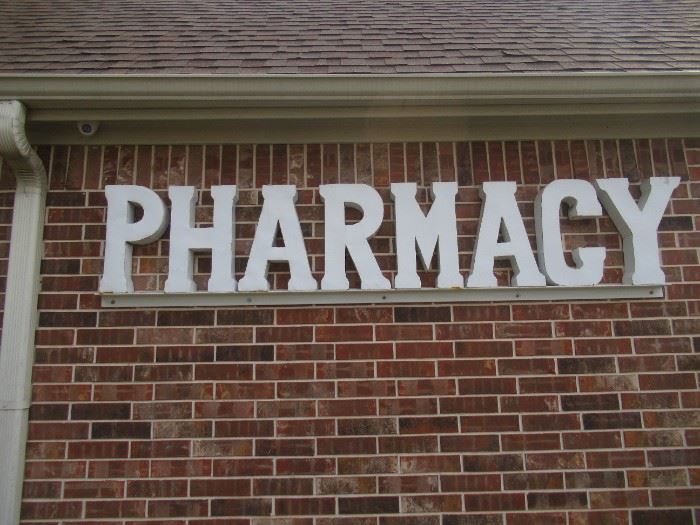 METAL PHARMACY SIGN 95 X 21 MUST BRING TOOLS AND LADDER TO REMOVE