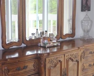 Long dressing table with trifold mirrors.