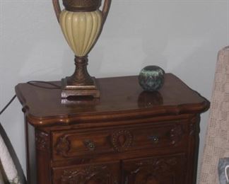 One of two matching night stands and table lamps.