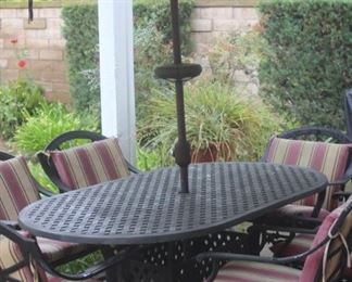 Patio table/chairs/cushions and umbrella.