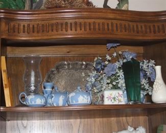 Shelves filled with crystal, bone china, figurines.