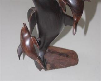 Iron wood dolphin statue.