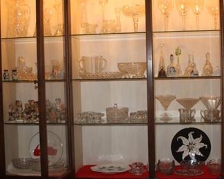 China cabinet filled with crystal and cut glass.