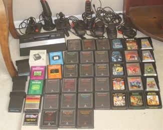 Vintage Atari 2600 Console and Joy Sticks and Controllers with many game cartridges.