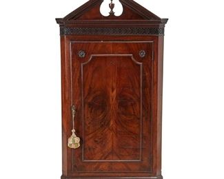 4024
An English Georgian-Style Mahogany Corner Cupboard
Late 19th century
The hanging cabinet surmounted by a broken pediment and fretwork carved band over a single-door concealing three scalloped shelves
53.75" H x 31.5" W x 17" D
Estimate: $300 - $500