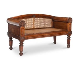 4027
An Anglo-Indian Wooden Bench
20th century
With carved wood with shell motif on the arms and apron; and woven cane seats and back
27" H x 51" W x 23.25" D
Estimate: $500 - $700