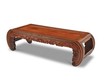 4034
A Chinese Carved Wood Kang Table
Mid/late 20th century
The rectangular, low table carved of mixed hardwoods with a meander apron and inward curved legs
13" H x 46" W x 18" D
Estimate: $400 - $600
