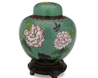 4037
A Chinese Cloisonne Lidded Jar
Circa 1930s-40s
The enamel cloisonne vessel with seafoam green ground and polychrome floral decoration on a wood stand
Overall: 11" H x 7" Dia.
Estimate: $600 - $800
