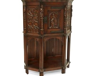 4045
A Gothic Revival Carved Wood Court Cupboard
Early 20th century
The raised, single-door cabinet with elaborately carved figural and foliate Gothic motifs, fitted with iron hardware and latch lock over an undertray and with a hinged drop-down back door
60" H x 41.5" W x 22.5" D
Estimate: $800 - $1,200
