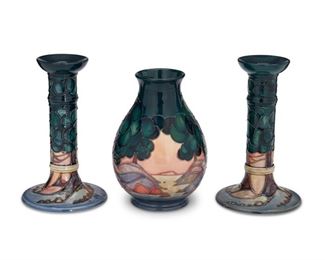 4047
A Group Of Moorcroft Pottery
Late 20th/early 21st century; Burslem, England
Each with Moorcroft backstamp; with further various dates and markings
Each glazed ceramic with trees in a landscape, comprising a pair of candlesticks and a vase, 3 pieces
Largest: 8.25" H x 5" Dia.
Estimate: $300 - $400