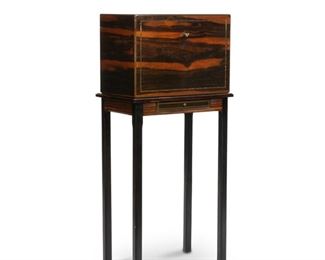 4063
An Alfred Dunhill Inlaid Rosewood Humidor On Stand
Mid-20th century
Marked: Dunhill / Made in France
Inlaid, lacquered humidor and stand; hydrometer on the interior of storage box; along with cigar cases, sterling silver cutter, and a gold filled cutter
With stand: 44.25" H x 20" W x 12.75" D
Estimate: $700 - $900