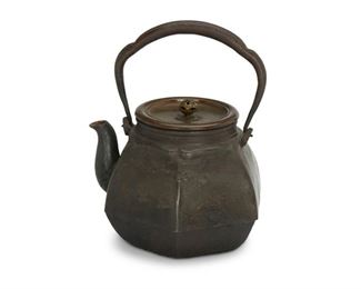 4086
A Japanese Cast Iron Tetsubin Tea Kettle
Early 20th century
Signed in Japanese characters to underside of lid
Decorated with a cast motif of grasses and birds in flight and decorative finial
8.5" H (with handle) x 5.5" W
Estimate: $300 - $500