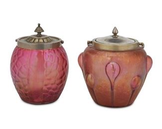 4096
Two Loetz-Style Art Glass Biscuit Barrels
Late 19th/early 20th century
Silver plate of second marked for Deykin & Harrison
Comprising an iridescent pink jar with oil spot finish and trailing bubbles fitted with a metal lid and handle (9.5" H x 6.5" Dia.) and an iridescent cranberry jar with a honeycombed-style design fitted with a silver-plated lid and handle (8" H x 5" Dia.), 2 pieces
Estimate: $200 - $400