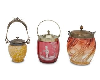 4097
Three Victorian Art Glass Biscuit Barrels
Late 19th/early 20th century
Comprising an Amberina glass jar with spiked surface design, a Mary Gregory cranberry glass jar, and a mottled yelllow condiment jar, each fitted with a silver-plated lid and handle, 3 pieces
Largest: 9.5" H x 5.25" Dia.
Estimate: $300 - $400