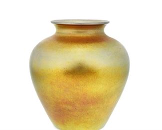 4103
A Steuben Aurene Glass Vase
Circa 1904-1933; Corning, New York
With engraved signature: Steuben / Aurene / 2683
The gold Aurene glass vase shaded pink with wide-shouldered body and flared neck
8.25" H x 7.5" Dia.
Estimate: $400 - $600