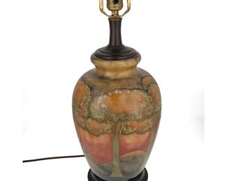 4106
A Moorcroft Pottery "Eventide" Table Lamp Base
20th century; Burslem, England
Marks to underside obscured by mounting
The glazed ceramic lamp with a sunset landscape scene, mounted to wood base, electrified
19.5" H x 8" Dia.
Estimate: $800 - $1,200