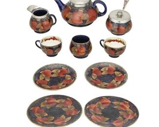 4108
A Group Of Moorcroft Pottery Table Items
Circa 1980s; Burslem, England
Each with Moorcroft backstamp; with further various dates and markings
Each glazed ceramic with pomegranate motif, some with silver-plated accents, comprising a teapot, covered sugar bowl with associated sterling spoon, a creamer, a waste bowl, two teacups, two saucers, and two plates, 11 pieces
Largest: 5" H x 8" W x 5.5" Dia.
0.65 oz. troy approximately
Estimate: $300 - $500
