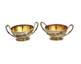 4116
A Pair Of Tiffany & Co. Master Salt Cellars
Circa 1853, directorship of J.C. Moore
Each marked: Tiffany & Co. / 2483 / Sterling / 5217 / M
Each with opposed handles and sprays of flowers with a gold wash interior, 2 pieces
Each: 2" H x 3.875" W x 3.75" D
5.22 oz. troy approximately
Estimate: $500 - $700