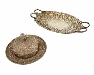 4165
Two American Sterling Silver Holloware Serving Items
Late 19th/early 20th century
Marked for Kirk and Justis & Armiger sterling
Each with similarly designed floral motif, comprising a Justis & Armiger oval handled tray (2" H x 14.5" W x 8.25" D) and an S. Kirk & Son butter dome (4" Hx 8" Dia.), 2 pieces
38.94 oz. troy approximately
Estimate: $800 - $1,200