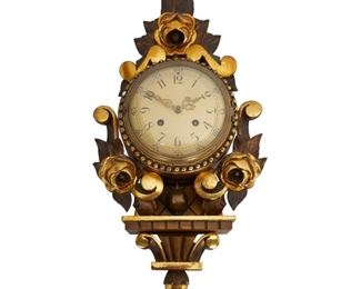 4170
A Swedish Gilt-Wood Cartel Clock
Mid-20th century
Signed to face: Westerstrand; Stamped on the verso: Gotene / Made in Sweden
With an enameled steel face set in a carved, gilt wood body with a scroll and floral rose motif
21" H x 12" W x 4.25" D
Estimate: $400 - $600