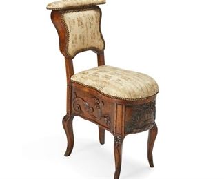 4176
A French Carved Wood Commode Chair
19th century
The carved wood chair with silk upholstered back and seat with nail head trim, lifting to reveal a glazed ceramic chamber pot
35" H x 15.5" W x 24" D
Estimate: $300 - $500