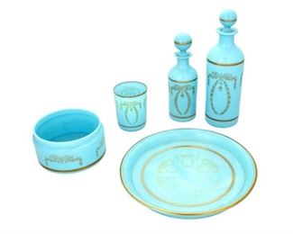 4177
A Set Of French Blue Opaline Glass Vanity Items
Circa 1930s-40s
Each decorated with gilt wreaths, comprising a tall stoppered flacon bottle, a small stoppered flacon bottle, a cup, a plate, and a round dish, 5 pieces
Largest: 9.5" H x 2.75" Dia.
Estimate: $400 - $600