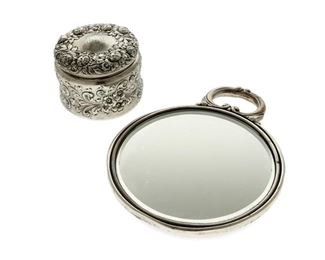 4182
Two Sterling Silver Vanity Items
20th century
Each marked for sterling
Comprising a hand mirror (7.25"H x 7.25" W x 5.75" D) and a lidded box (2.75" H x 3.25" Dia.), each with floral motifs, 2 pieces
15.825 gross oz. troy approximately
Estimate: $200 - $300
