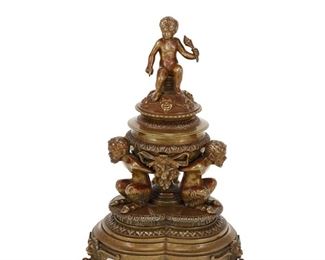 4191
A Bronze Figural Inkwell
Late 19th/early 20th century
The trefoil shaped inkwell with a single lidded well surmounted by a putto and supported by satyrs
9.5" H x 6.5" Dia.
Estimate: $300 - $500