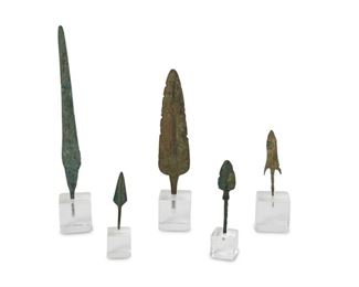 4201
A Group Of Bronze Arrow And Spear Points
Possibly Classical antiquity or later
Likely ancient or reproduction of ancient design; various arrow and spear tips, each slightly different form, with age appropriate verdigris and accumulated deposits; each with accompanying square Lucite stand, 5 pieces
Largest: 9.5" H x 1.5" W; smallest: 3.5" H x 1" W
Estimate: $300 - $500