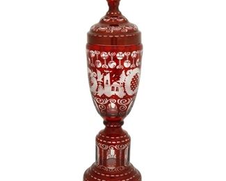 4207
A Bohemian Cut-Glass Lidded Vase
1886
Signed and dated: Stice / 1886
The art glass vase intaglio cut from ruby to clear with floral motifs centering a stag and castles
12.75" H x 4.75" Dia.
Estimate: $400 - $600
