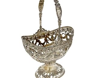 4223
A German .800 Silver Reticulated Basket
Late 19th century
Appears unmarked
Decorated with floral swags and putti
18.25" H x 12.125" W x 8" D
37.47 oz. troy approximately
Estimate: $700 - $900