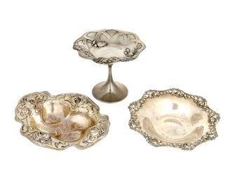 4254
A Group Of American Sterling Silver Holloware Items
Early 20th century
Each marked for sterling, with various maker's marks
Each with an Art Nouveau-style floral design, comprising a small compote and two small nut dishes, maker's include Tiffany & Co. and William B. Kerr, 3 pieces
Largest: 5" H x 5.75" Dia.
13.29 oz. troy approximately
Estimate: $400 - $600